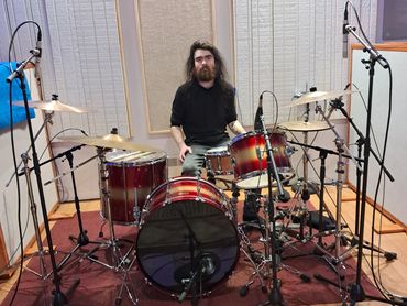 Drummer performing in studio